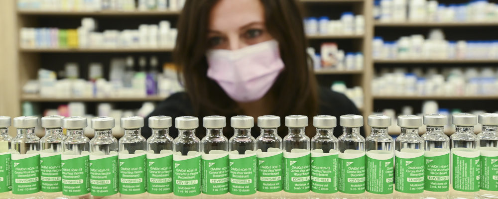 Pharmacist Barbara Violo arranges all the empty vials of the Oxford-AstraZeneca COVID-19 vaccines that she has provided to customers. Nathan Denette/The Canadian Press