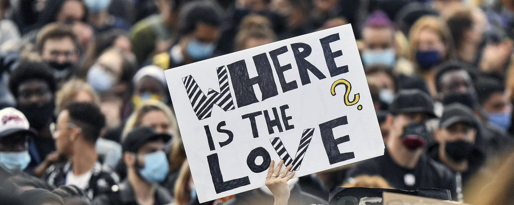 A sign reads "where is the love?" as thousands of people demonstrate in Cologne, Germany, Saturday June 6, 2020. Martin Meissner/AP Photo.