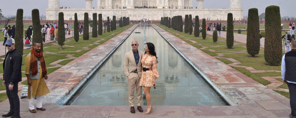 Amazon CEO Jeff Bezos and his partner Lauren Sánchez stand for photographs in front of the Taj Mahal in Agra, India on Jan. 21, 2020. Pawan Sharma/AP Photo.