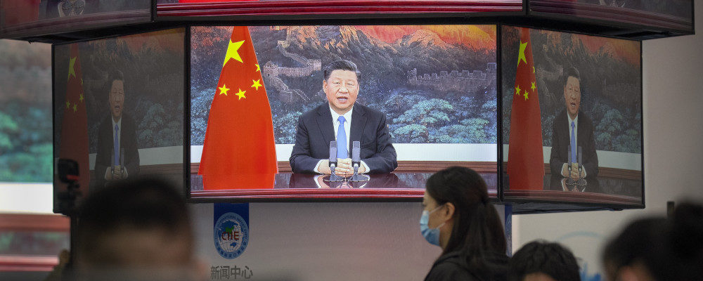 Video screens show Chinese President Xi Jinping as he delivers an address in Shanghai on Nov. 4, 2020. Mark Schiefelbein/AP Photo.
