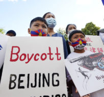Children hold signs during a demonstration by a coalition representing Tibetans, Uyghurs, Southern Mongolians, Hong Kongers, Taiwanese and Chinese rights activists Wednesday, June 23, 2021 in Boston. Charles Krupa/AP Photo.