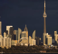 Light from the sunset hits the skyline in Toronto. Mark Blinch/The Canadian Press.