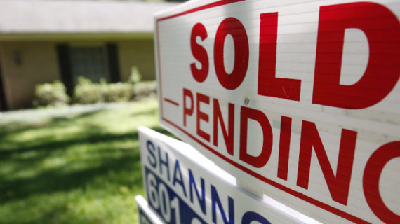 A file photo shows a house with a "sold pending" sign fixed on the realtor's sign. Rogelio V. Solis/AP Photo.