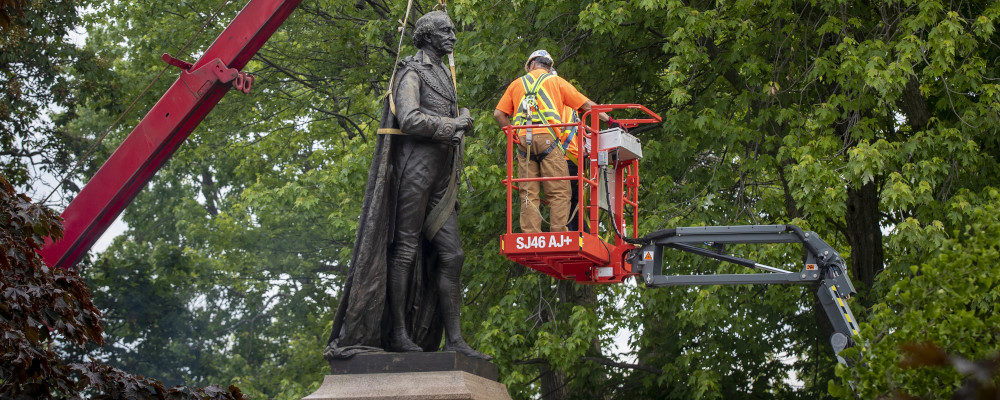The statue of Sir John A Macdonald is removed by workers in Kingston, Ontario on June 18, 2021. Lars Hagberg/The Canadian Press.