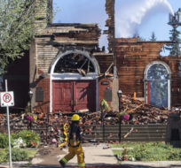 St. Jean Baptiste Parish Catholic church is shown in Morinville, Alberta, on June 30, 2021 as firefighters put out hot spots. The Catholic Church in northern Alberta has been destroyed by what RCMP are calling a suspicious fire. Jason Franson/The Canadian Press.