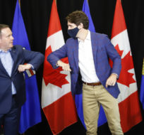 Prime Minister Justin Trudeau elbow bumps with Alberta Premier Jason Kenney as the two meet in Calgary on July 7, 2021. Jeff McIntosh/The Canadian Press.