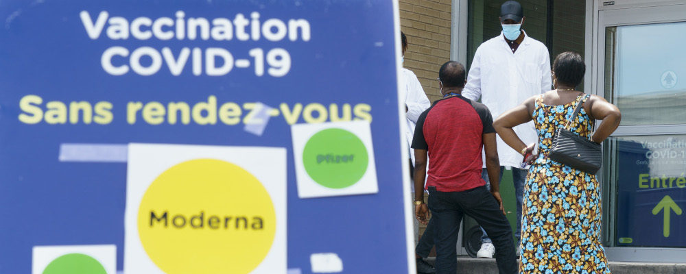 People are screened as they enter a COVID-19 vaccination clinic in Montreal, on Thursday, July 22, 2021. Paul Chiasson/The Canadian Press.