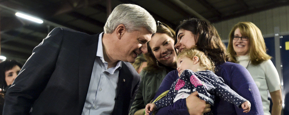 Conservative leader Stephen Harper talks with mothers and their children after speaking during a campaign stop in Saskatoon on October 7, 2015. Nathan Denette/The Canadian Press.