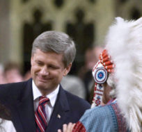 Assembly of First Nations Chief Phil Fontaine, right, watches as Canadian Prime Minister Stephen Harper thanks Beverley Jacobs, head of the Native Women's Association of Canada, after she responded to the government's apology for Indian residential schools in the House of Commons on June 11, 2008. Tom Hanson/The Canadian Press.