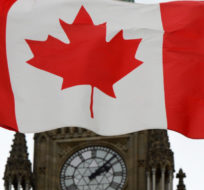A Canadian flag blows in front of the Peace Tower on Parliament Hill on Oct. 24, 2012. Sean Kilpatrick/The Canadian Press.