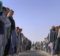 Afghan nationals line up and wait for security checks in Pakistan before entering Afghanistan through a common border crossing point in Chaman, Pakistan, Thursday, Aug. 26, 2021. AP Photo.