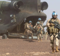 Canadian infantry and medical personnel disembark a Chinook helicopter as they take part in a medical evacuation demonstration on the United Nations base in Gao, Mali on December 22, 2018. Adrian Wyld/The Canadian Press.