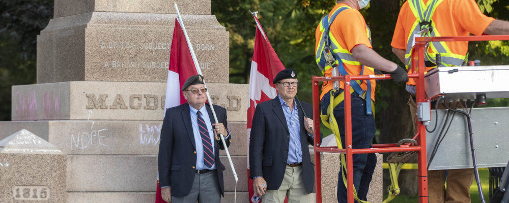 Veterans protest before the removal of a statue Sir John A. Macdonald in Kingston, Ontario on Friday June 18, 2021.  Lars Hagberg/The Canadian Press.