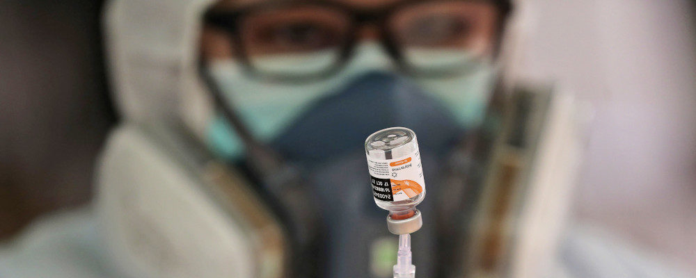 A medical worker shows a vial of the Sinovac COVID-19 vaccine manufactured by Indonesian state-owned pharmaceutical company Biofarma. Tatan Syuflana/AP Photo.