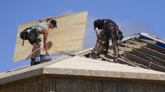 Builders work on the roof of a home in a new subdivision in the Ottawa suburb of Kanata, on Friday, July 30, 2021. Justin Tang/The Canadian Press.
