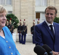 France's President Emmanuel Macron, right, and German Chancellor Angela Merkel give a press conference prior to a meeting at the Elysee Palace, in Paris on Sept. 16, 2021. Michel Euler/AP Photo.