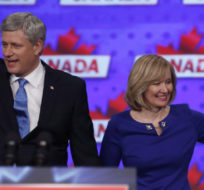 Conservative leader Stephen Harper along with his wife Laureen wave to supporters in Monday, Oct. 19, 2015 in Calgary. Jeff McIntosh/The Canadian Press.