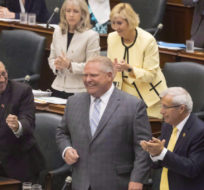 Ontario Premier Doug Ford is applauded by his PC Party members during Question Period at the Ontario Legislature in Toronto on July 30, 2018. The Ontario government passed a controversial bill to reduce the size of Toronto city council. Chris Young/The Canadian Press.