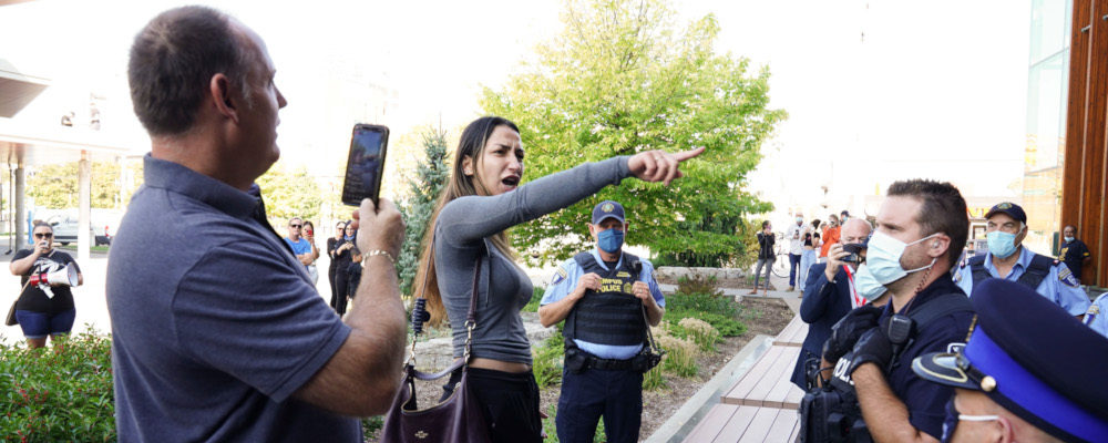 Security keeps watch as protesters wait for Liberal leader Justin Trudeau to leave the University of Windsor in Windsor, Ont., on Friday, Sept. 17, 2021. Sean Kilpatrick/The Canadian Press.