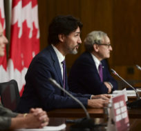 Prime Minister Justin Trudeau speaks as he's joined by Minister of Infrastructure and Communities Catherine McKenna, left, and Chair of the Board of the Canada Infrastructure Bank Michael Sabia, right, during a press conference in Ottawa on Oct. 1, 2020. Sean Kilpatrick/The Canadian Press.