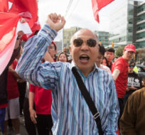 A pro-China counter-protester shouts at Hong Kong anti-extradition bill protesters during opposing rallies, in Vancouver, on Saturday August 17, 2019. Darryl Dyck/The Canadian Press.