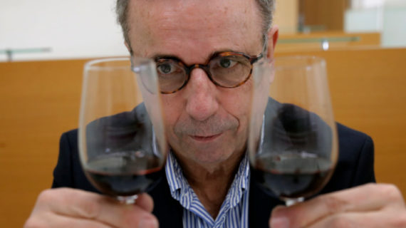 Bordeaux Mayor Pierre Hurmic checks glasses of wine, during a tasting session, with one glass containing wine that spent a year orbiting the world in the International Space Station, at the Institute for Wine and Vine Research in Villenave-d'Ornon, southwestern France, Monday, March 1, 2021. Christophe Ena/AP Photo