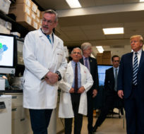 Deputy Director at the Vaccine Research Center at the National Institutes of Health, Dr. Barney Graham, speaks with President Donald Trump during a tour of the Viral Pathogenesis Laboratory at the National Institutes of Health, Tuesday, March 3, 2020. Evan Vucci/AP Photo.