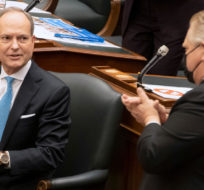 Ontario Finance Minister Peter Bethlenfalvy is applauded by Premier Doug Ford after delivering the Provincial Budget in the Ontario Legislature in Toronto on Wednesday March 24, 2021. Frank Gunn/THE CANADIAN PRESS.