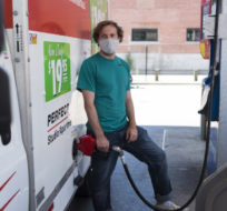 Colin Cote fills up a u-haul truck with gas at a Esso gas station in Toronto on Tuesday, June 15, 2021. Tijana Martin/The Canadian Press. 