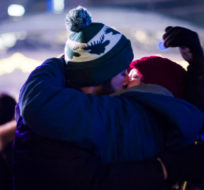 Alex Koval and Andre Prysciec share an intimate moment after marking the beginning 2018 during New Years Eve celebrations held at Nathan Phillips Square in Toronto, Monday, Jan 1, 2018. Christopher Katsarov/The Canadian Press.