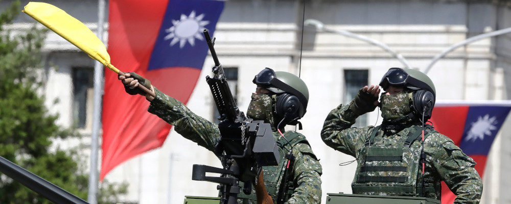 Taiwanese soldiers salute during National Day celebrations in front of the Presidential Building in Taipei, Taiwan, Sunday, Oct. 10, 2021. Chiang Ying-ying/AP Photo.