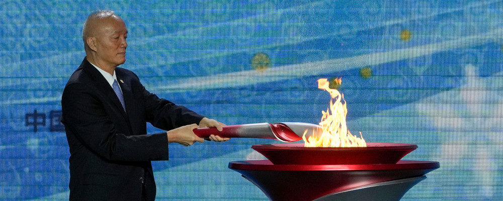 Cai Qi, Beijing Communist Party secretary lits up the Olympic cauldron during a welcome ceremony for the Frame of Olympic Winter Games Beijing 2022, held at the Olympic Tower in Beijing, Wednesday, Oct. 20, 2021. Andy Wong/AP Photo.