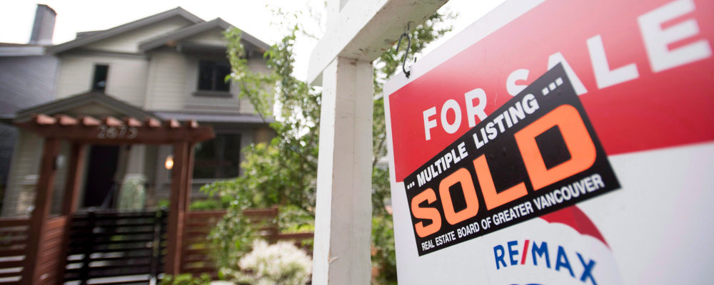 A real estate sign is pictured in Vancouver on June 12, 2018. Jonathan Hayward/The Canadian Press.