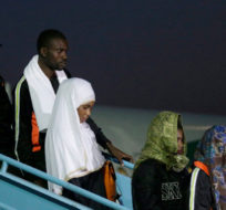 In this Tuesday, Dec. 5, 2017 file photo, Nigerian returnees from Libya disembark from a plane upon arrival at the Murtala Muhammed International Airport in Lagos, Nigeria. An emergency effort has begun to repatriate thousands of migrants stranded in camps across Libya, but now the returnees are posing a challenge. Back home in countries across Africa, they face the same conditions that led them to leave: high unemployment, often weak economies, an increasingly harsh climate. Sunday Alamba/AP Photo.