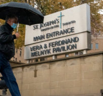 A man walks into the main entrance to St Joseph’s Health Centre in Toronto, Monday, Oct. 19, 2020. Frank Gunn/The Canadian Press. 
