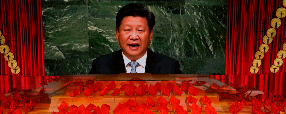 In this June 28, 2021, file photo, Chinese President Xi Jinping is displayed on a screen as performers dance at a gala show ahead of the 100th anniversary of the founding of the Chinese Communist Party in Beijing. Ng Han Guan/AP Photo.