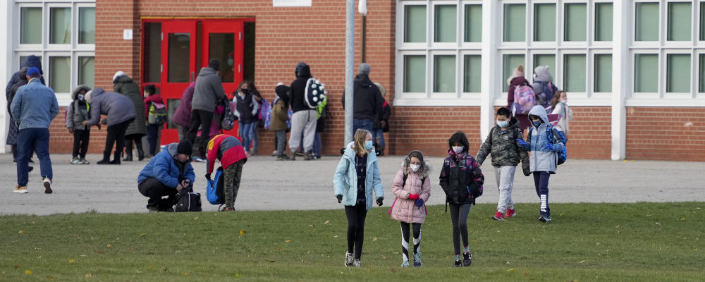 Parents pick up their children as they are dismissed from Dixie Public School in Mississauga on Nov. 22, 2021. Nathan Denette/The Canadian Press.