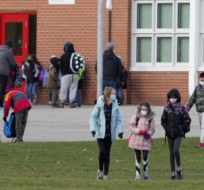 Parents pick up their children as they are dismissed from Dixie Public School in Mississauga on Nov. 22, 2021. Nathan Denette/The Canadian Press.