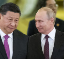 Chinese President Xi Jinping, center left, and Russian President Vladimir Putin, center right, enter a hall for talks in the Kremlin in Moscow, Russia, June 5, 2019. Alexander Zemlianichenko/AP photo.