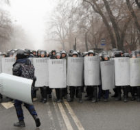 Riot police officers stand ready to stop demonstrators during a protest in Almaty, Kazakhstan, Wednesday, Jan. 5, 2022. Demonstrators protesting rising fuel prices have broken into the mayor's office in Kazakhstan's largest city and flames were seen coming from inside, according to local news reports. Protests against a sharp increase in prices for liquefied gas began this week in the country's west and spread to Almaty and the capital Nur-Sultan. Vladimir Tretyakov/AP Photo.