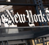 A sign for The New York Times hangs above the entrance to its building on May 6, 2021 in New York. Mark Lennihan, File/AP Photo.