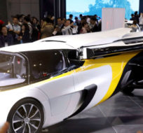 A visitor takes a photo of the Aeromobil, a flying car from Slovakia, during the China International Import Expo in Shanghai, Monday, Nov. 5, 2018. Ng Han Guan/AP Photo.