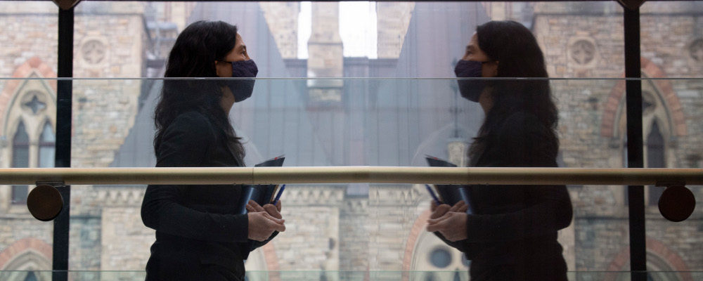Chief Public Health Officer Theresa Tam is reflected in a wall as she leaves a news conference Tuesday January 5, 2021 in Ottawa. Adrian Wyld/The Canadian Press. 