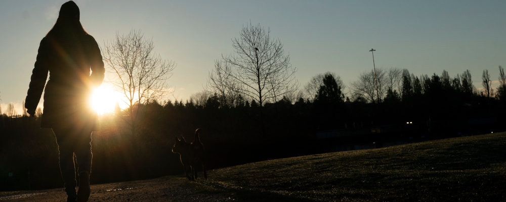 The sun rises over the mountain as a woman takes a walk in Vancouver, Monday, January 18, 2021.  Jonathan Hayward/The Canadian Press. 