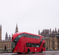 A double decker bus crosses Westminster Bridge against the backdrop of the Palace of Westminster, during a snow fall in London, Sunday, Jan. 24, 2021. Alberto Pezzali/AP Photo.
