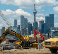 Construction crews work on the Port Lands renewal project in Toronto on Tuesday June 1, 2021. Frank Gunn/The Canadian Press.