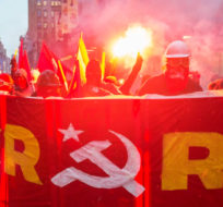 Protesters light flares during a May Day demonstration Monday, May 1, 2017 in Montreal. Anti-capitalists marched through downtown Montreal on Monday to disturb what they claimed were the corporate playgrounds of the scheming rich.For the 10th consecutive year, a group calling itself the "anticapitalist convergence" organized a march in the city to celebrate International Workers' Day, also known as May Day. Ryan Remiorz/The Canadian Press. 