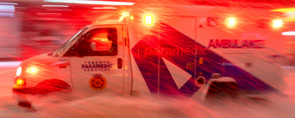 An ambulance races through a winter storm in Toronto on Monday January 17, 2022. Frank Gunn/The Canadian Press.
