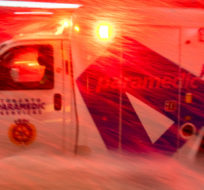 An ambulance races through a winter storm in Toronto on Monday January 17, 2022. Frank Gunn/The Canadian Press.
