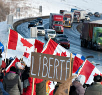 Hundreds of people gather by TransCanada Highway 20 to show their support to truckers heading to Ottawa to protest against COVID-19 restrictions, Friday, Jan. 28, 2022  in Levis, Que. Jacques Boissinot/The Canadian Press.